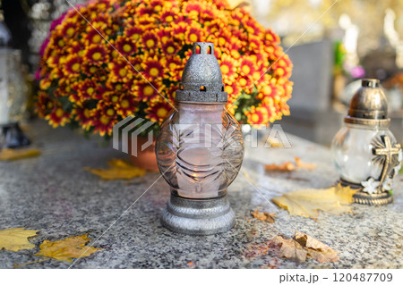 Decorated graves at a cemetery on All Saints Day (Wszystkich Swietych) in Poland. 120487709
