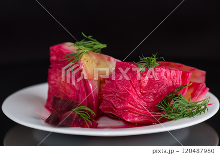 pickled cabbage with beets and carrots, in a plate, isolated on black background pickled cabbage with beets and carrots, in a plate, isolated on black background 120487980