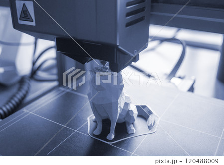 3D printer close-up. The process of working of 3D printer. 3D printer printing object from molten plastic. 3D printer creating model by flowing liquid plastic from an extruder. Printing technology 120488009