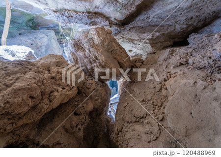 Tourists Trekking through Narrow Limestone Caves in Bemaraha National Park. 120488969