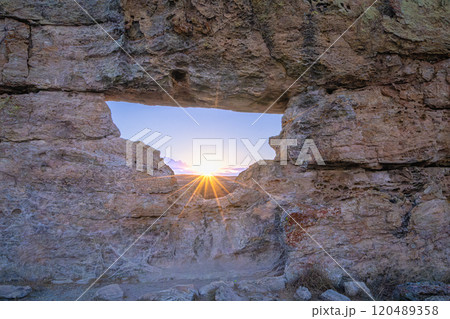 Sunset Through Natural Rock Window in Isalo National Park, Madagascar. 120489358
