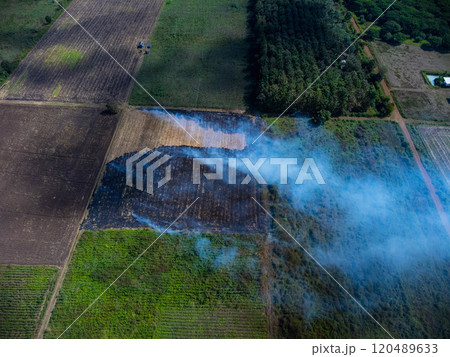 Aerial view of farmers burning corn residue after harvest. Corn field fire after harvest. 120489633