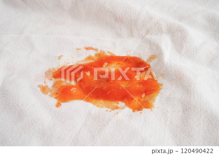 Dirty spicy sauce stain on cloth to wash with washing powder, cleaning housework. Dirty spicy sauce stain on cloth to wash with washing powder, cleaning housework. 120490422