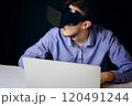 A person uses virtual reality on a laptop, blending technology with productivity and innovation in a modern workspace 120491244