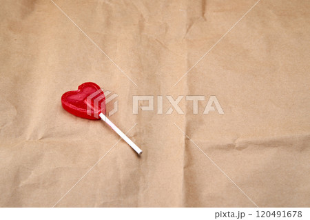 Solitude of a red heart-shaped lollipop. 120491678