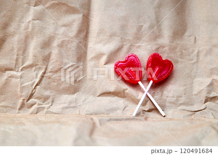 Representation of love through two red lollipops shaped like a red heart. Representation of love through two red lollipops shaped like a red heart. 120491684