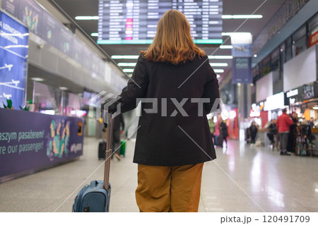 Portrait of positive cheerful traveler woman hold ticket ready enjoy voyage tour passenger walk in airport terminal to boarding gate. Attractive beautiful female tourist excited to go travel abroad by Portrait of positive cheerful traveler woman hold ticket ready enjoy voyage tour passenger walk in airport terminal to boarding gate. Attractive beautiful female tourist excited to go travel abroad by 120491709