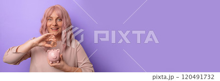 Young caucasian woman holding piggybank and bitcoin isolated on light lilac background inviting to come with hand. Young caucasian woman holding piggybank and bitcoin isolated on light lilac background inviting to come with hand. 120491732