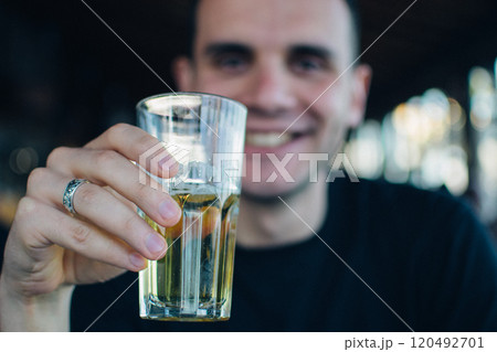 a young man enjoys a meal in a Greek restaurant 120492701