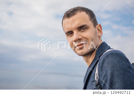 young man with a backpack on the seashore 120492711