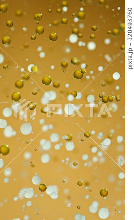 Macro Shot of Moving Oil and Milk Bubbles on Golden Background, Cosmetics Concept 120493760