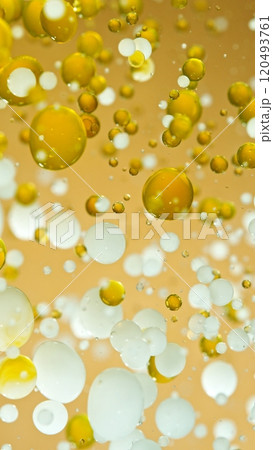 Macro Shot of Moving Oil and Milk Bubbles on Golden Background, Cosmetics Concept 120493761