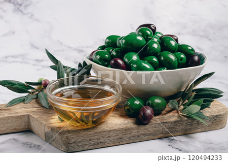 Chalkidiki olives, classic Greek green olives, in a bowl on a cutting board, top view, without people, 120494233