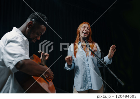 Singing and Playing Guitar in Live Performance Setting Singing and Playing Guitar in Live Performance Setting 120494605