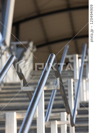 Metallic Railing on high staircase In Building, Stainless steel railing for fall protection. Metallic Railing on high staircase In Building, Stainless steel railing for fall protection. 120494909