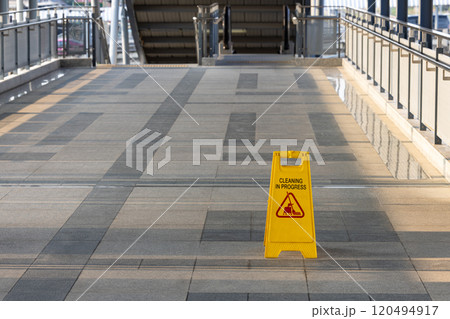 Sign showing warning of cleaning process area, Yellow sign that alerts for cleaning process, Warning symbol of Slippy floor for pedestrian. 120494917