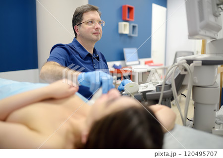 Mammologist doctor examines a woman breasts and lymph nodes using ultrasound. Mammography and ultrasound scanning are main methods of instrumental diagnosis of mammary glands. Breast cancer 120495707