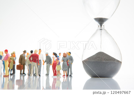 miniature people. people of different ages and statuses stand in line near the hourglass 120497667
