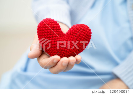 Asian elder senior woman patient holding red heart in hospital. Asian elder senior woman patient holding red heart in hospital. 120498054