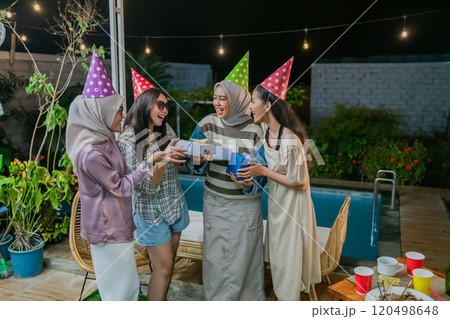 Cheerful friends celebrate joyfully, wearing party hats and embodying friendship 120498648