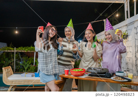 A Joyful Celebration with Friends at a Vibrant and Colorful Outdoor Party A Joyful Celebration with Friends at a Vibrant and Colorful Outdoor Party 120498823