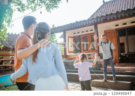 asian grandfather waving hand greeting granddaughter asian grandfather waving hand greeting granddaughter 120498847