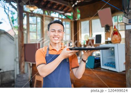 asian coffee shop waiter standing holding tray 120499024