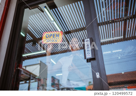 female entrepreneur holding open sign information 120499572