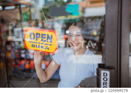 asian saleswoman holding open sign start operating business asian saleswoman holding open sign start operating business 120499579