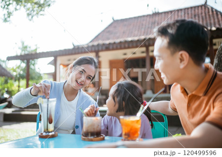 asian mother taking care daughter lunch time asian mother taking care daughter lunch time 120499596