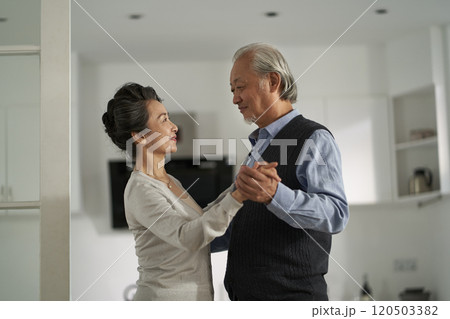 loving asian old couple dancing at home loving asian old couple dancing at home 120503382