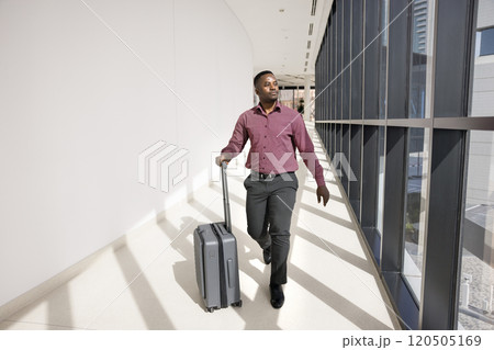 Young African American businessman walking to airport flight gate Young African American businessman walking to airport flight gate 120505169