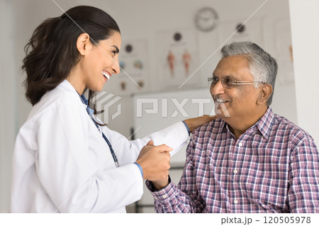 Cardiologist touch shoulder holding hand of older patient 120505978