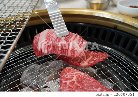 Korean barbecue, closeup of raw beef sirloin on grill 120507351