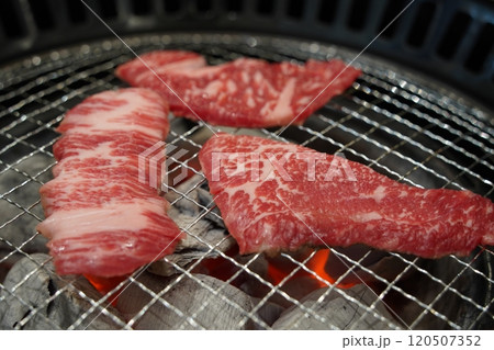 Korean barbecue, closeup of raw beef sirloin on grill 120507352