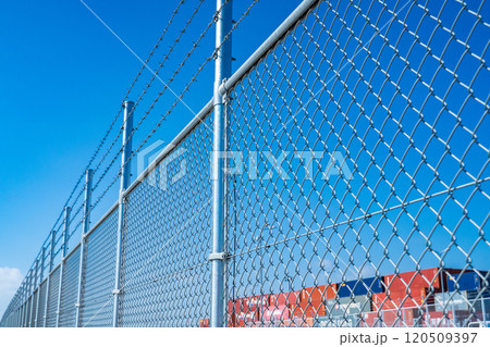 神戸市　ポートアイランドのコンテナターミナル整備工事と有刺鉄線のついた柵 120509397