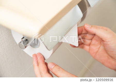 新しいトイレットペーパーを三角折りするミドル女性の手元 新しいトイレットペーパーを三角折りするミドル女性の手元 120509916