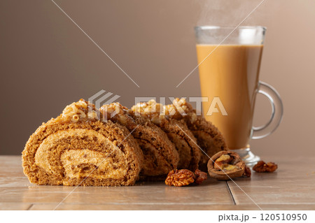 Dessert with walnuts and coffee latte on a beige background. Dessert with walnuts and coffee latte on a beige background. 120510950