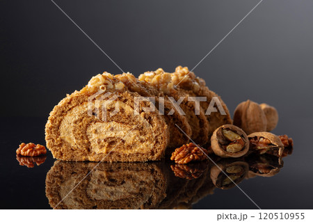 Dessert with walnuts on a black reflective background. Dessert with walnuts on a black reflective background. 120510955