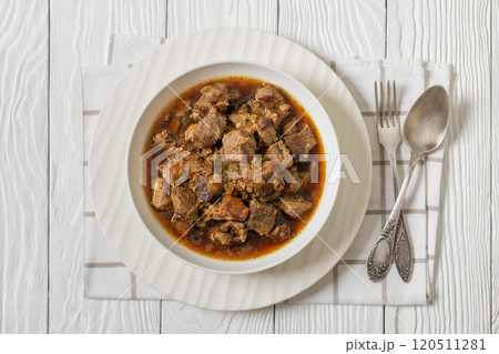 beer braised pork stew in a white bowl beer braised pork stew in a white bowl 120511281