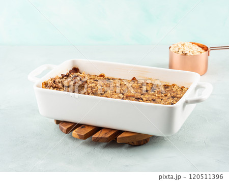 Vegan oatmeal banana cake in white baking pan on turquoise Vegan oatmeal banana cake in white baking pan on turquoise 120511396