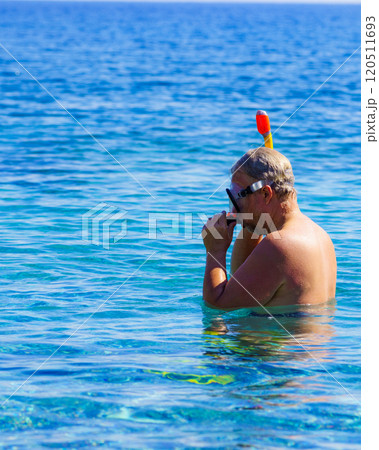 Man with snorkeling tube in sea Man with snorkeling tube in sea 120511693