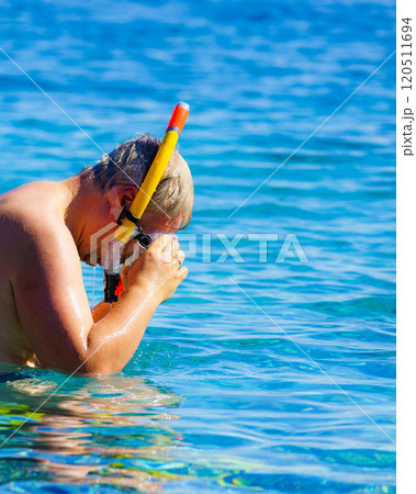 Man with snorkeling tube in sea Man with snorkeling tube in sea 120511694