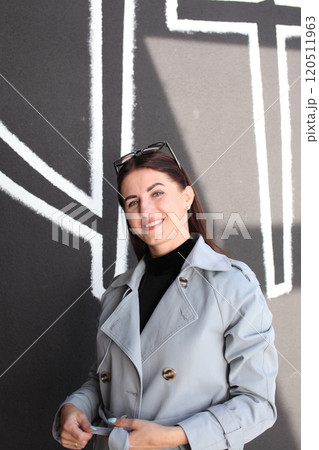 young pretty brunette woman posing emotional outside on neutral background young pretty brunette woman posing emotional outside on neutral background 120511963