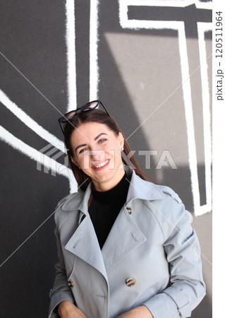 young pretty brunette woman posing emotional outside on neutral background 120511964