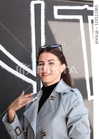 young pretty brunette woman posing emotional outside on neutral background young pretty brunette woman posing emotional outside on neutral background 120511965