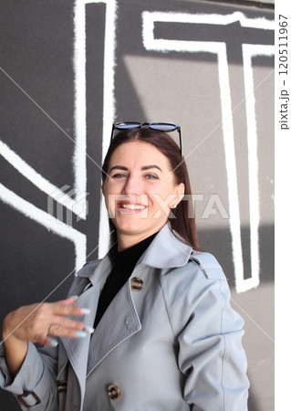 young pretty brunette woman posing emotional outside on neutral background 120511967