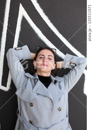 young pretty brunette woman posing emotional outside on neutral background young pretty brunette woman posing emotional outside on neutral background 120511971
