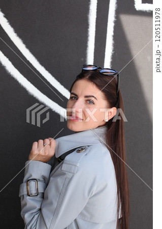 young pretty brunette woman posing emotional outside on neutral background young pretty brunette woman posing emotional outside on neutral background 120511978