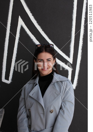 young pretty brunette woman posing emotional outside on neutral background young pretty brunette woman posing emotional outside on neutral background 120511983
